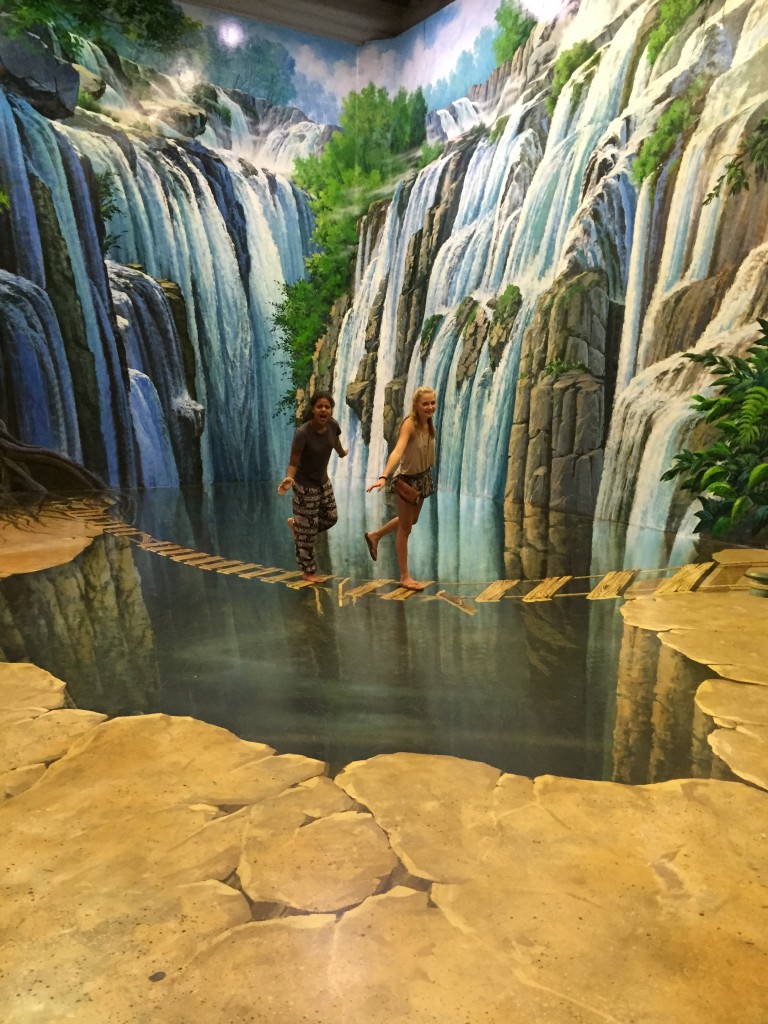 Evie and Maya make a narrow escape across the falls at the Art in Paradise museum. 