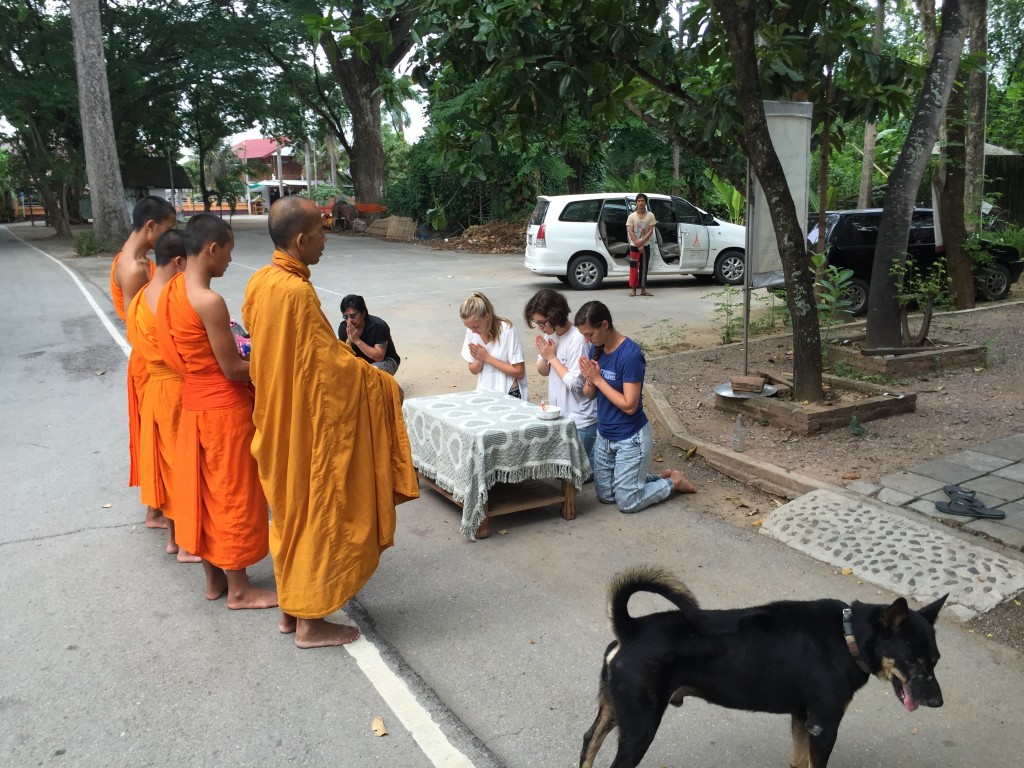 Several students volunteered to present alms one morning as monks from the neighborhood made their daily rounds. Alms are given in the form of offerings of food, drinks and money, and give merit to those who make the offering for the good health and good fortune of their family. 