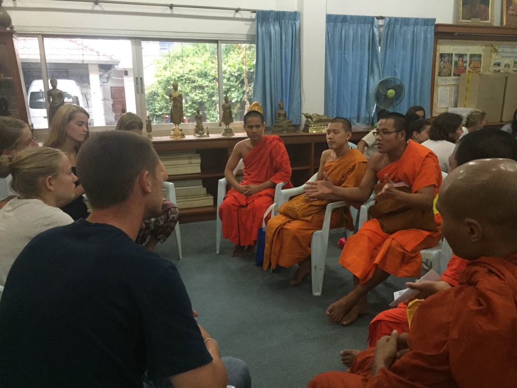 Students engage in an inspiring chat with local monks to ask questions about the role of Buddhism in Thailand and their daily lives.